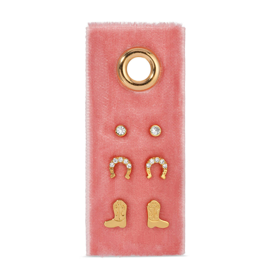 Set of gold earrings on a pink velvet card with a gold ring design.