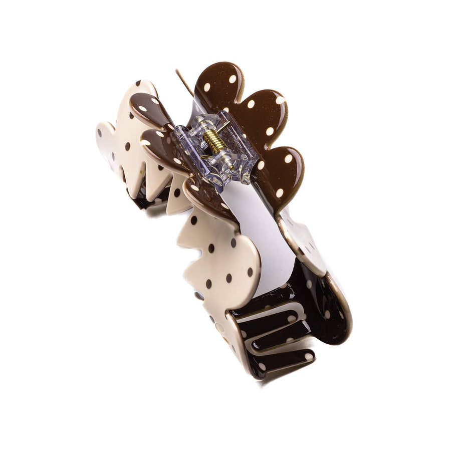 Decorative hair claw with polka dot design on a cream background