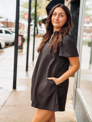 Short-sleeve black V-neck mini dress with side pockets.