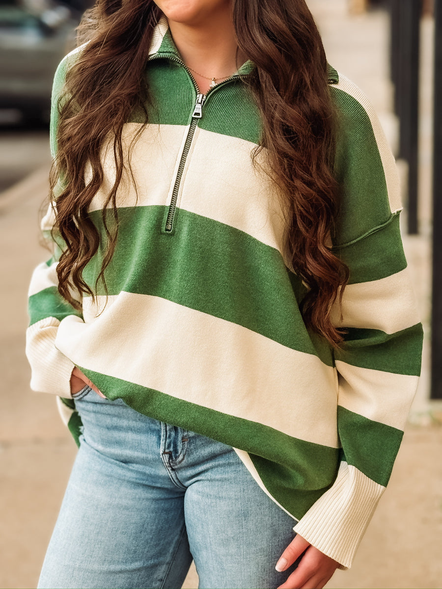 Green and cream striped quarter-zip pullover.
