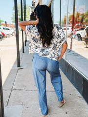 Light blue wide-leg pants with a drawstring waist, front seam detail, and relaxed fit