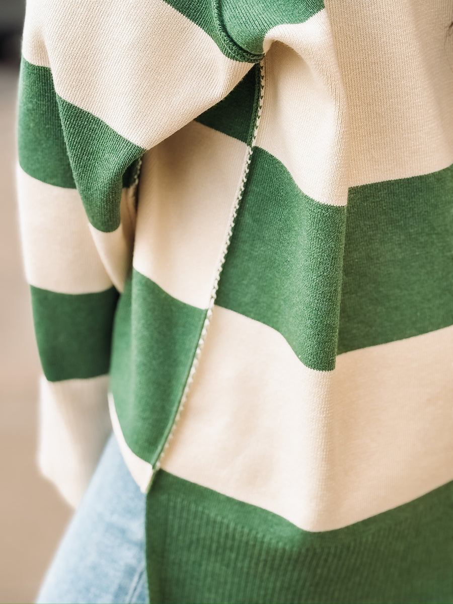 Green and cream striped quarter-zip pullover.