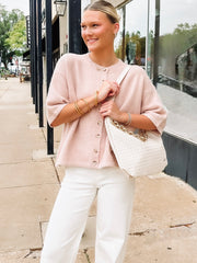 cream woven shoulder purse with leather strap and chain strap.