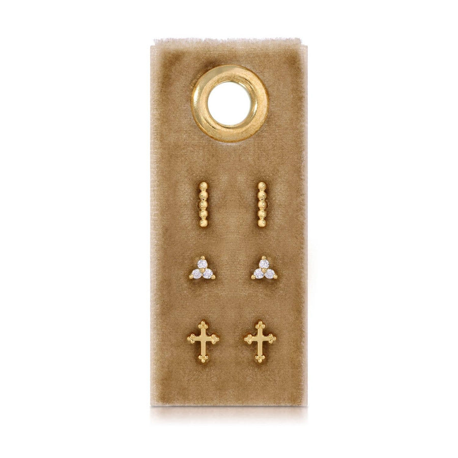 Set of gold and paveearrings on a brown velvet card with a gold ring on a white background