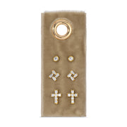 Set of gold and crystal earrings on a beige card with a gold ring design.