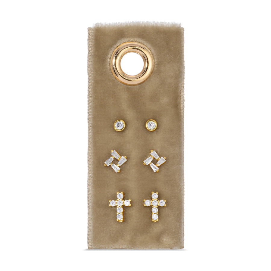 Set of gold and crystal earrings on a beige card with a gold ring design.