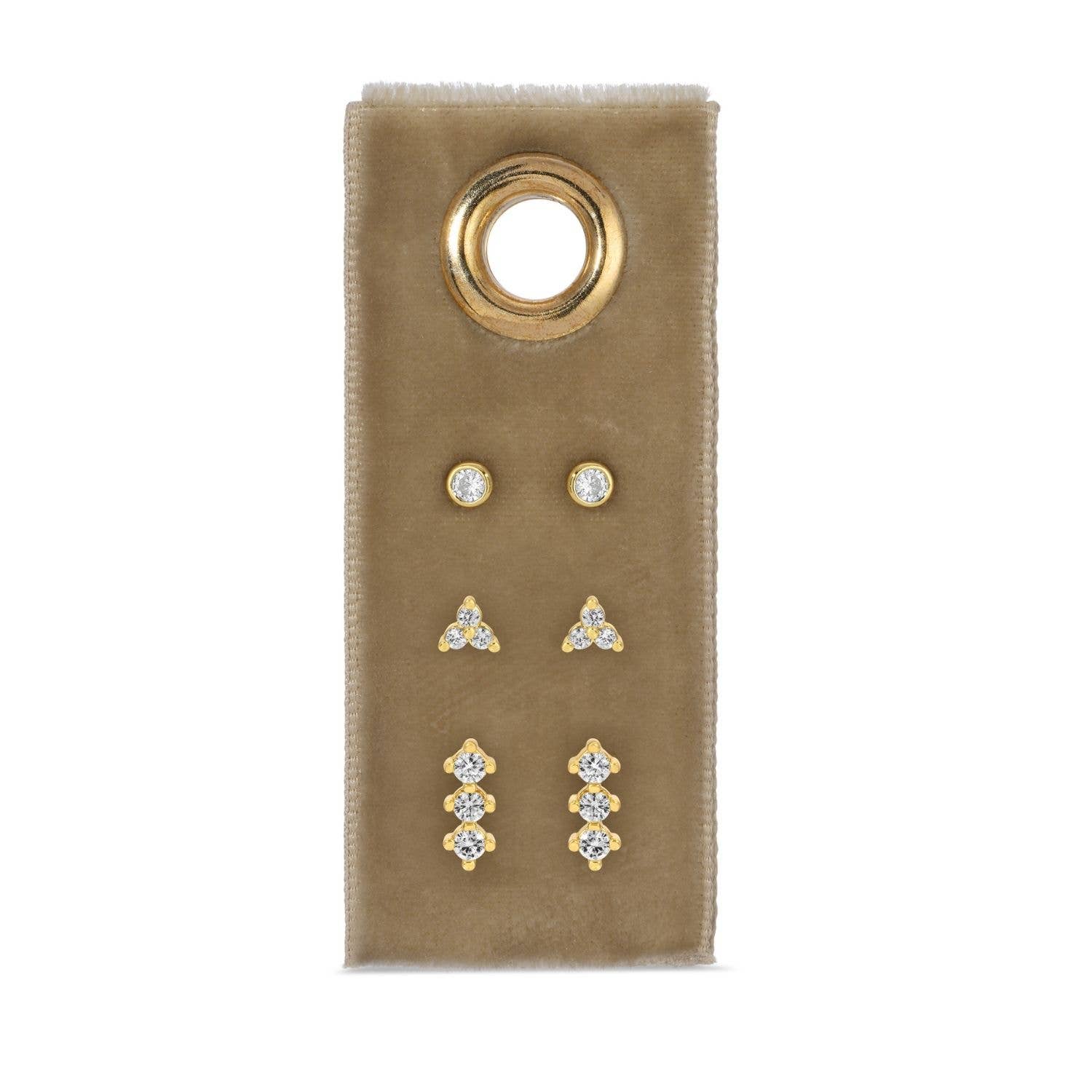 Set of gold and cz earrings on a beige card with a gold ring design.