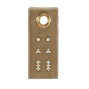 Set of gold and cz earrings on a beige card with a gold ring design.