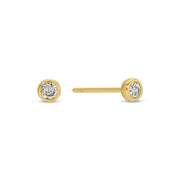 Gold stud earrings with clear gemstones on a white background