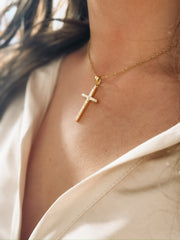 A short dainty chain with a CZ cross pendant.