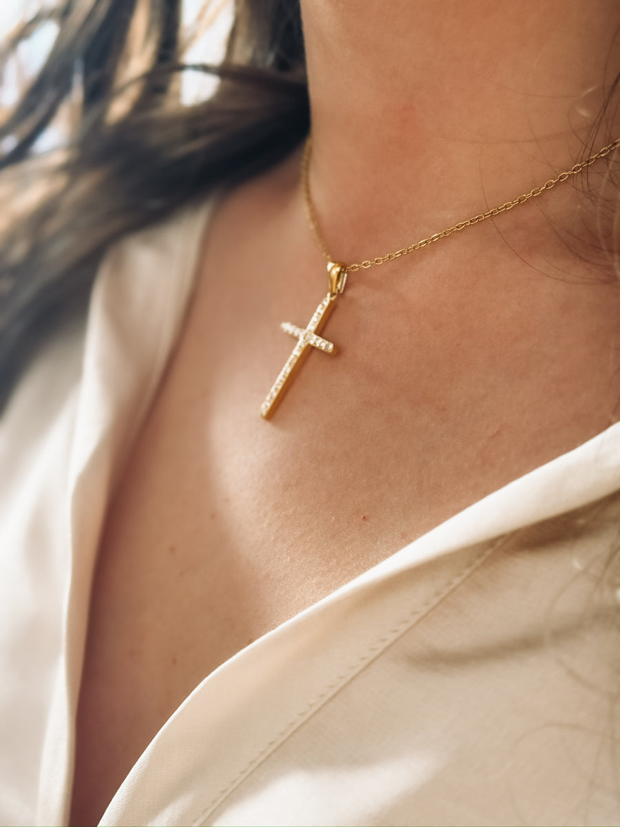 A short dainty chain with a CZ cross pendant.