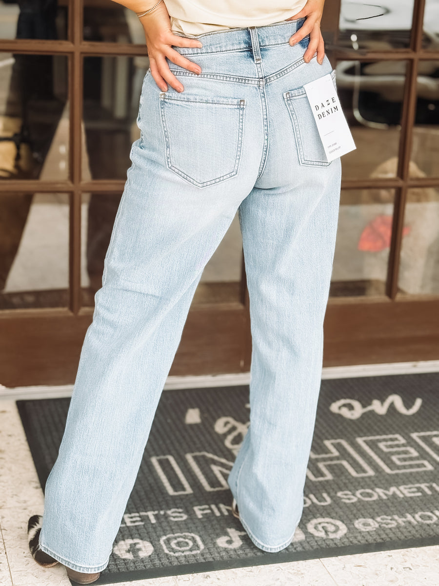 Light blue jeans being worn with a store interior background