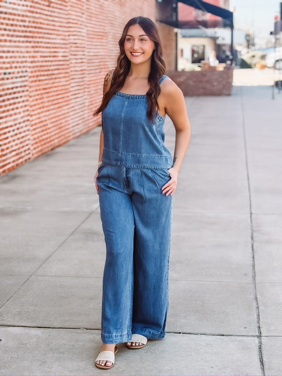 Sleeveless denim top paired with matching wide leg trouser in a relaxed two piece outfit.
