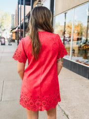 Tomato red short sleeve mini dress with eyelet detailing on the hem and sleeves. 