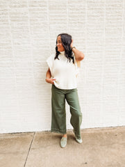 Olive green soft denim cropped jeans with eyelet detailing at the hem.