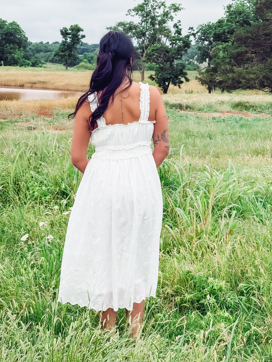 White eyelet sleeveless midi dress.
