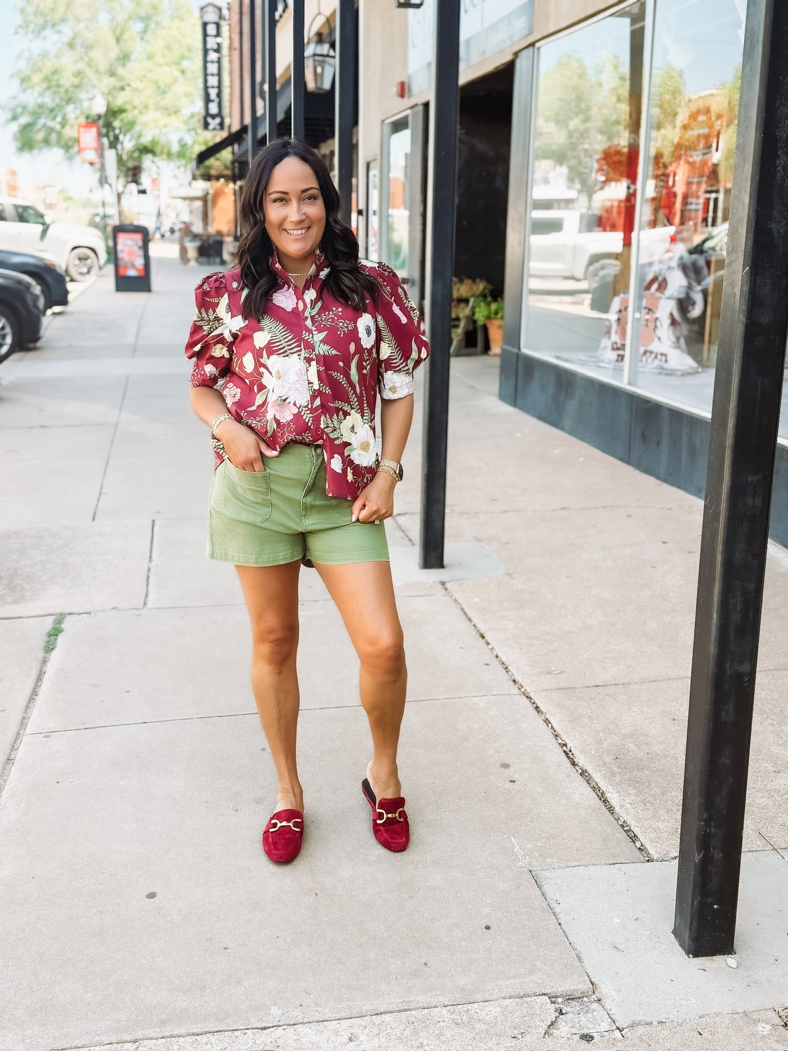 Wine-colored floral blouse with a ruffle neckline and button-up front