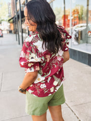  Wine-colored floral blouse with a ruffle neckline and button-up front