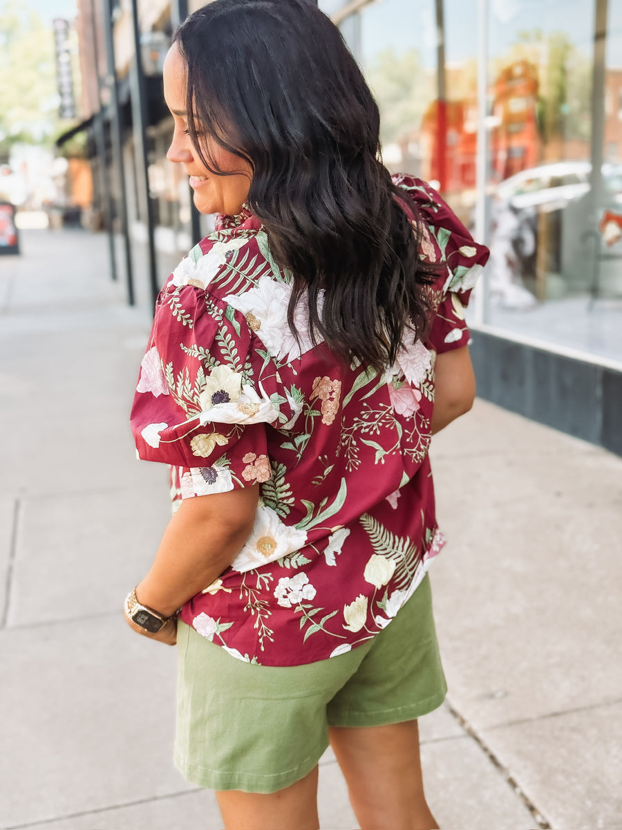  Wine-colored floral blouse with a ruffle neckline and button-up front
