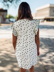 Off white flutter sleeve mini shift dress with black polka dots and a small v neckline.