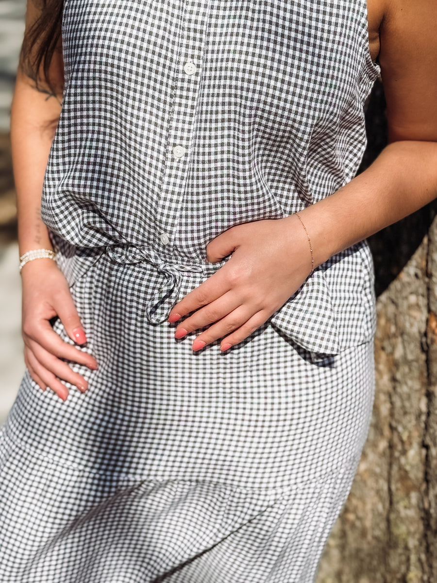 Person wearing a black and white checkered dress with a blurred background