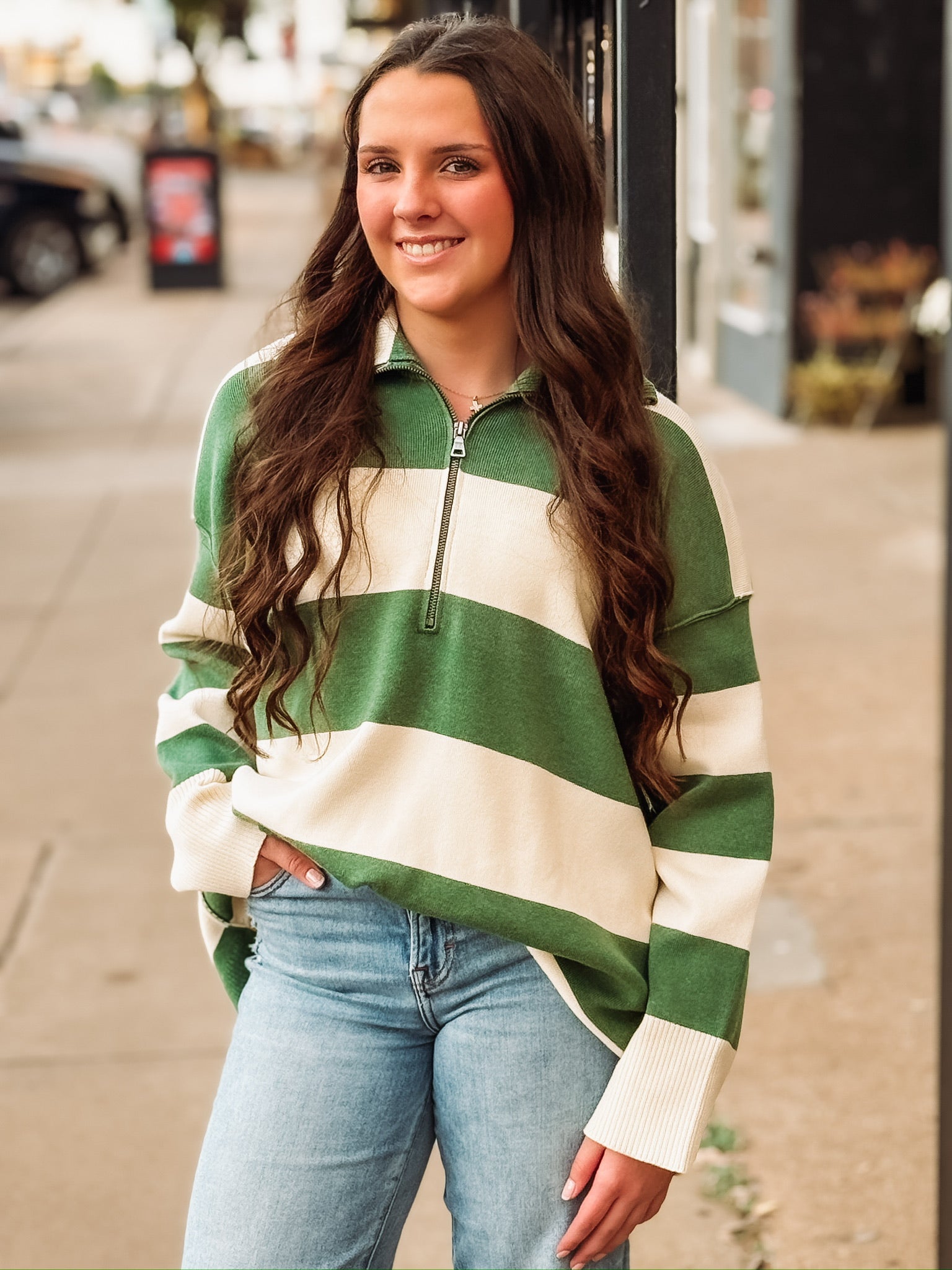 Green and cream striped quarter-zip pullover.