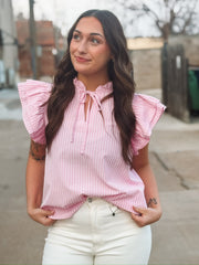 Pink ruffle sleeve pinstriped blouse with a ruffle neckline and a self tie detail.