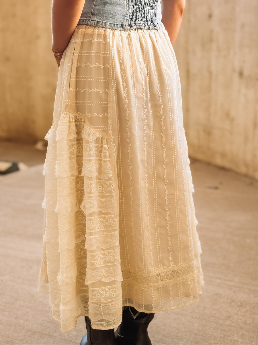 Feminine cream lace skirt featuring delicate embroidery and layered ruffles