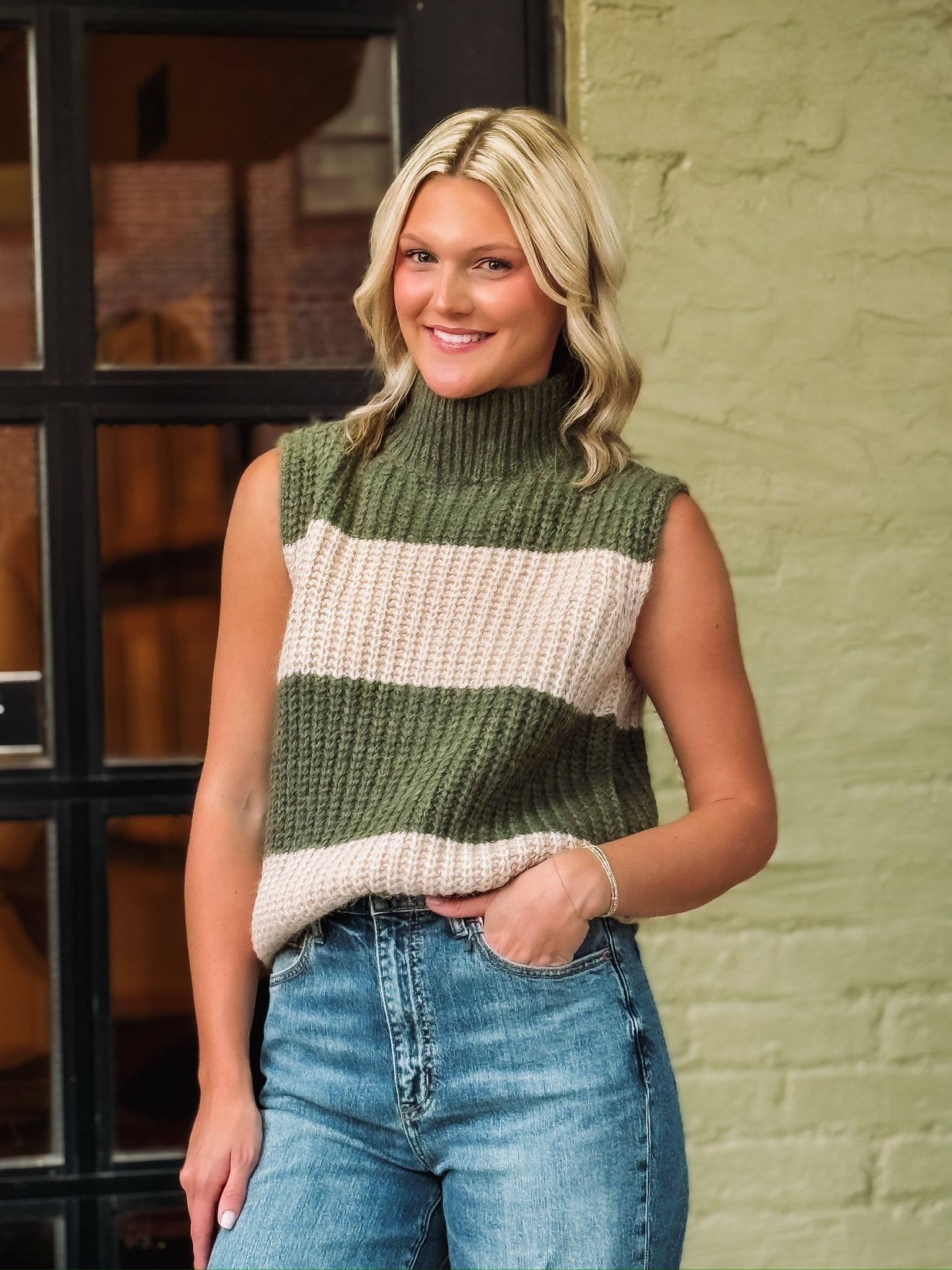 Thick olive and creamed striped knitted sleeveless turtle neck top.