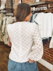 White long sleeve blouse with tonal checkered texture and shiver balloon sleeves.