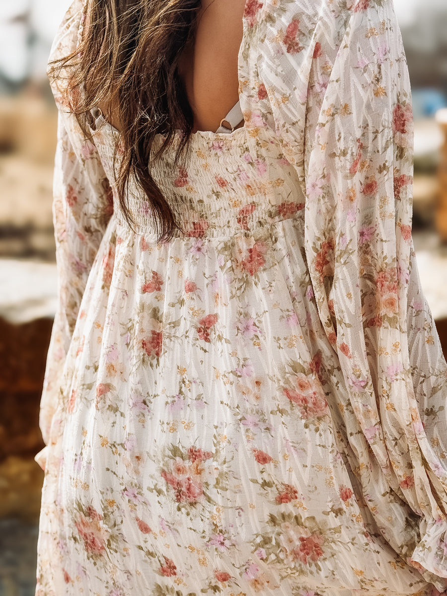 Floral dress with long sleeves and a blurred background