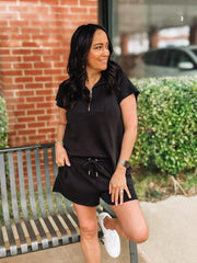 Black short sleeve scuba short set with gold sipper and end cap details from Mary Square.