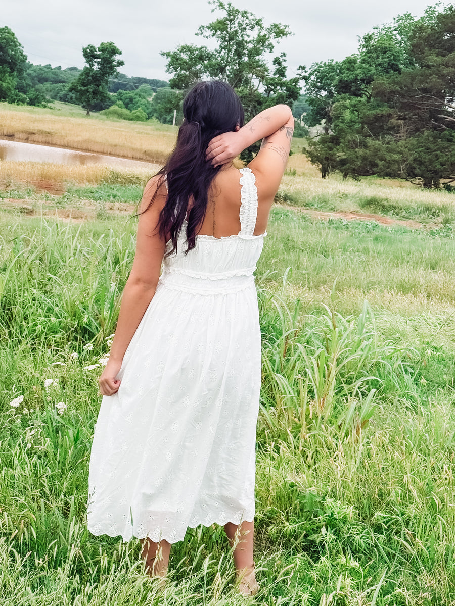 White eyelet sleeveless midi dress.