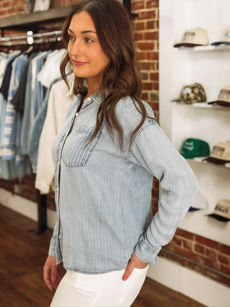 Light wash denim blouse with multi white stripes and button-up front