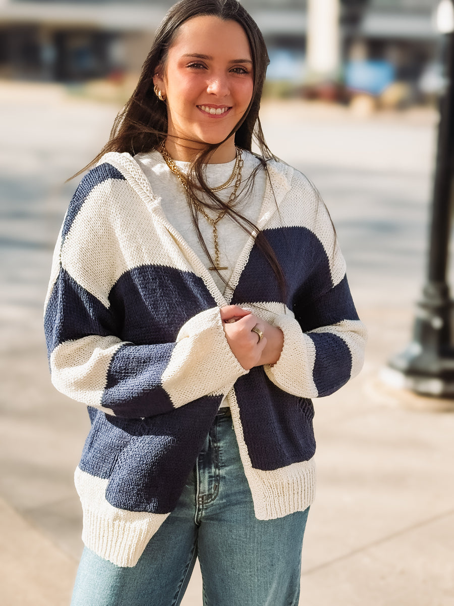 Woman wearing a blue and white striped sweater with a blurred background