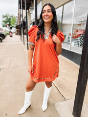 Orange above the knee length dress wit cheetah print trim.