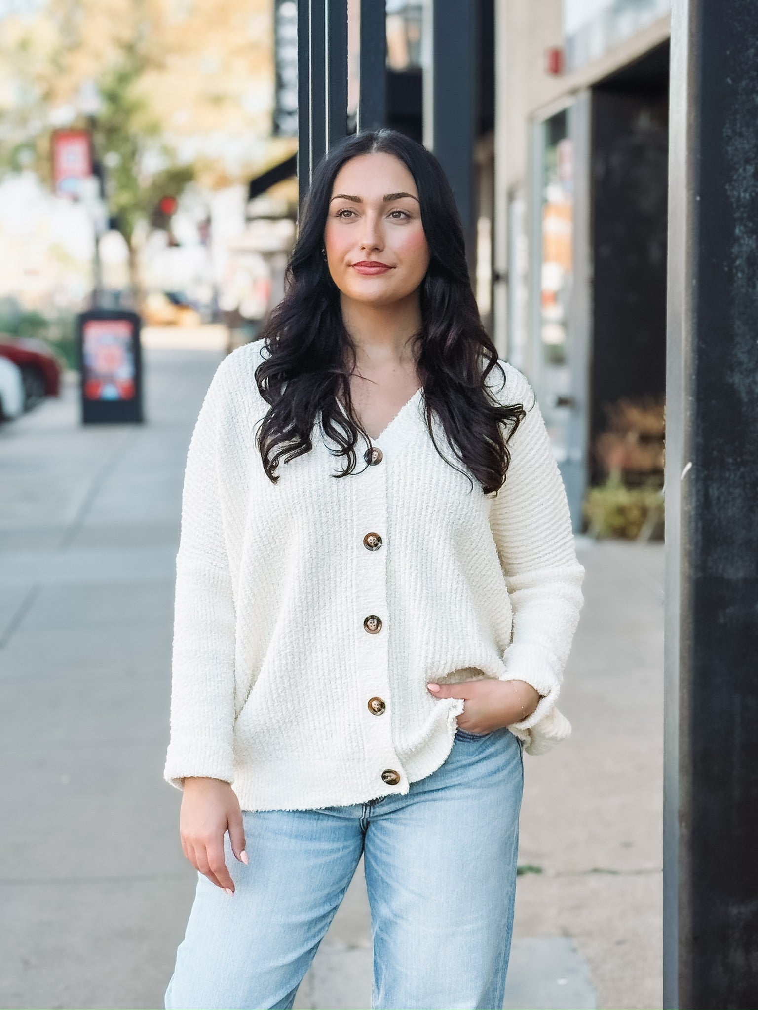 Cream long sleeve oversized cardigan with a v neck and tortoise buttons.