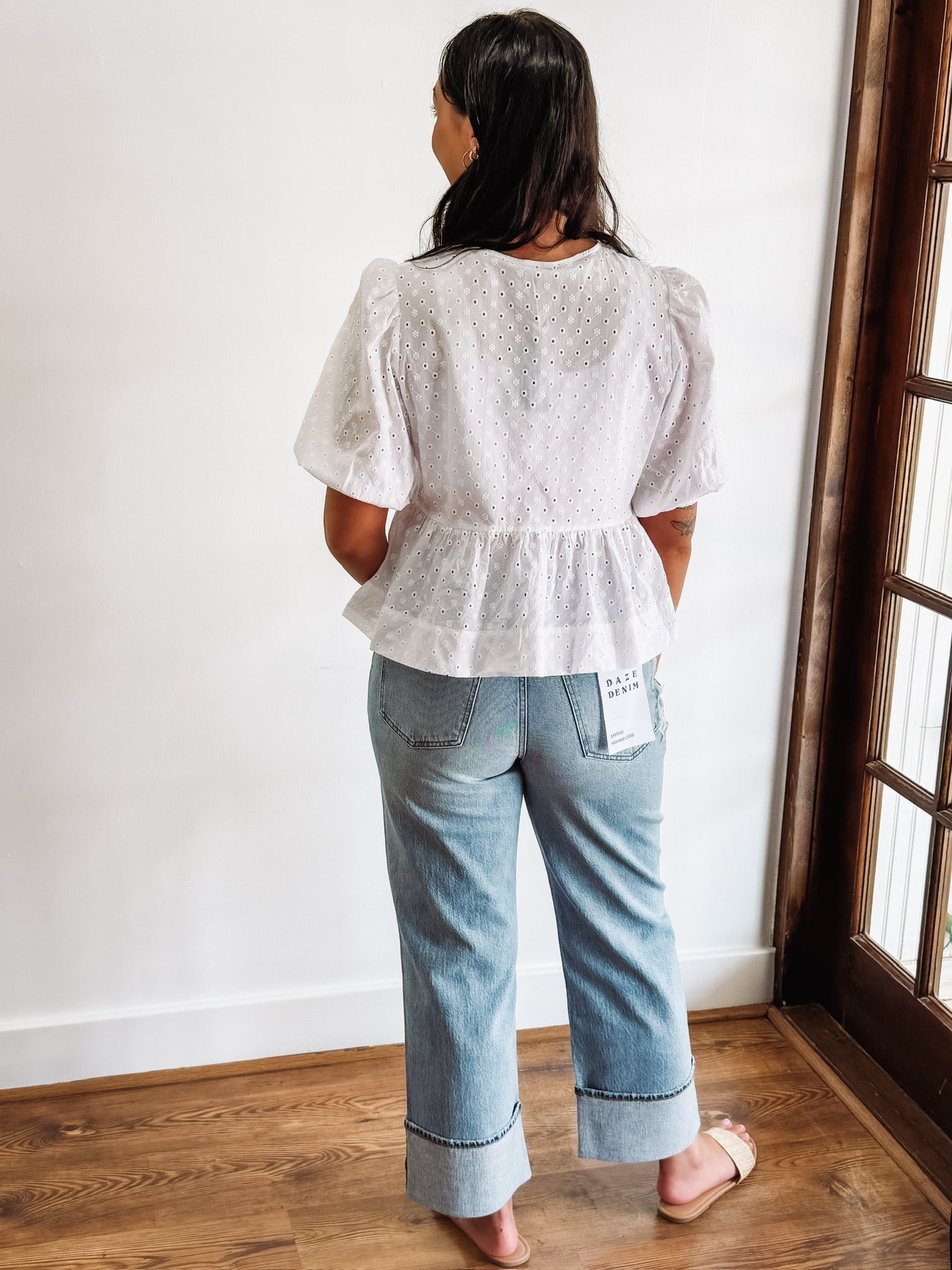 white peplum top with cut out eyelet details and bow tie front