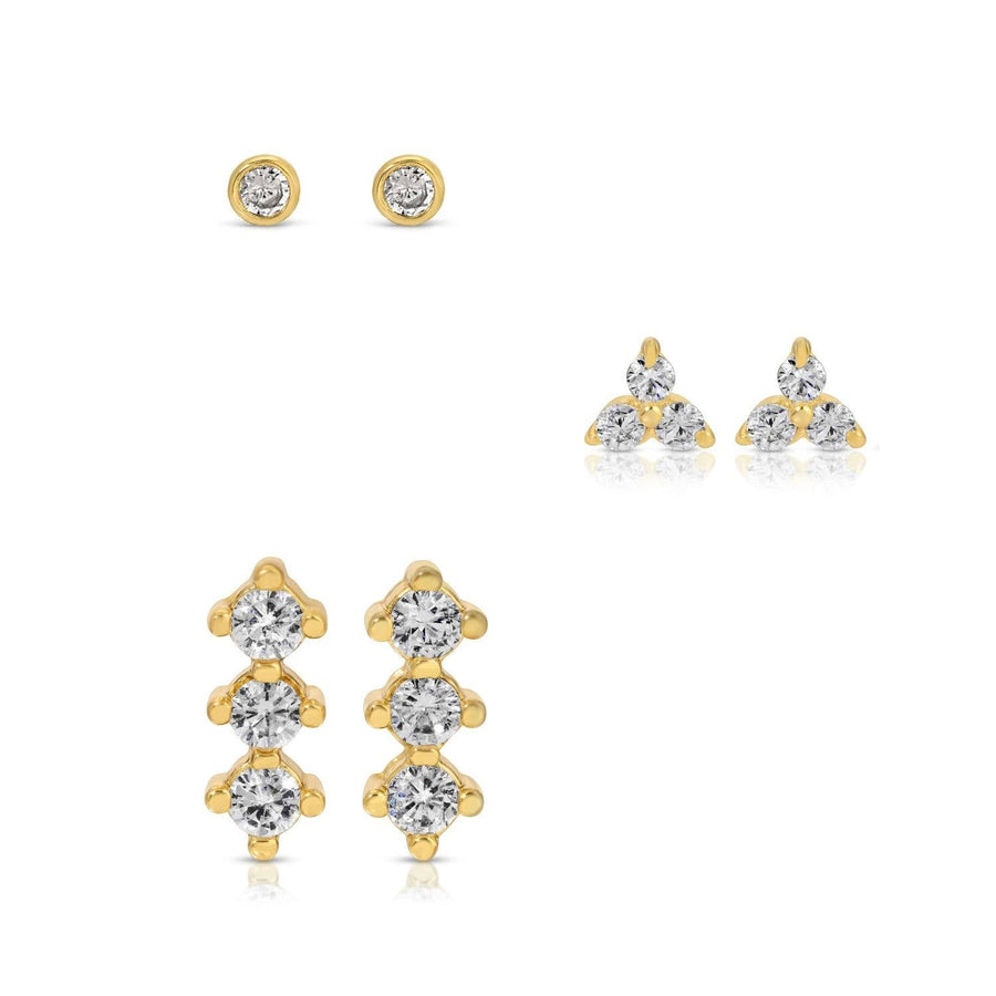 Gold and crystal stud earrings on a white background