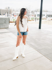 White pintuck spaghetti strap top with adjustable straps and a fit and flare look.