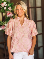 Blush pink short puff sleeve blouse with a champagne raised floral jacquard and china ruffle collar.