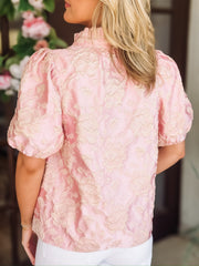 Blush pink short puff sleeve blouse with a champagne raised floral jacquard and china ruffle collar.