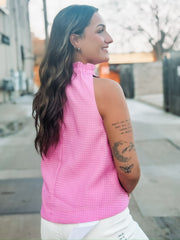 Textured pink top featuring a feminine bow tie neckline and relaxed fit