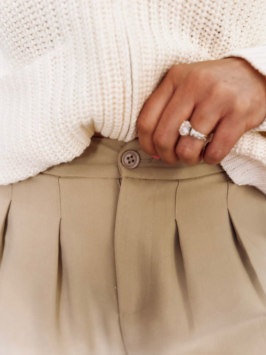 Womens pleated cropped trouser pants with front pockets and faux dress pant pockets on the back.