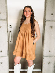 Camel colored embroidered sleeveless mini dress with ruffle hem and pleated detailing.