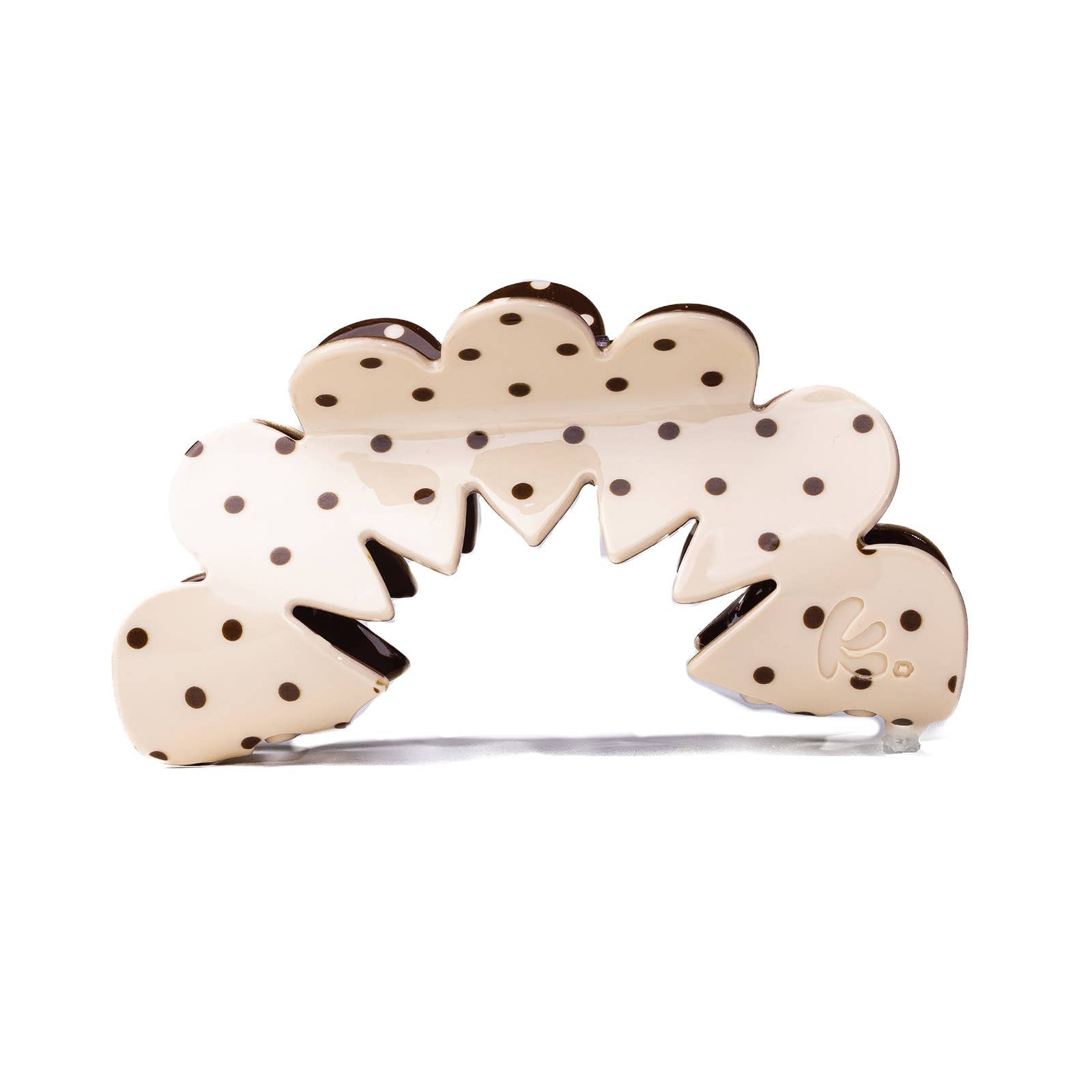 Decorative hair claw with polka dot design on a cream background