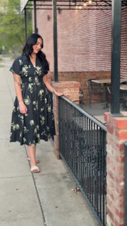 Short sleeve navy floral midi dress with v neck and zip front closure and smocked waist.