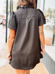 Short-sleeve black V-neck mini dress with side pockets