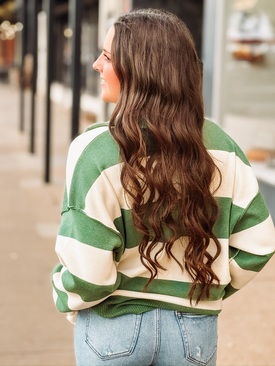 Green and cream striped quarter-zip pullover.
