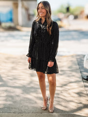 Black long sheer sleeved mini dress with a ruffle button up design.